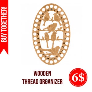 May include: Wooden thread organiser with 32 holes, featuring a bird design. The organiser is oval shaped and made of light brown wood.