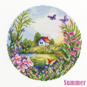 May include: A cross-stitch embroidery design featuring a summer scene with a small house, a pond, flowers, and butterflies. The design is circular and has a light blue sky with white clouds. The text "Summer" is written in pink at the bottom of the design.