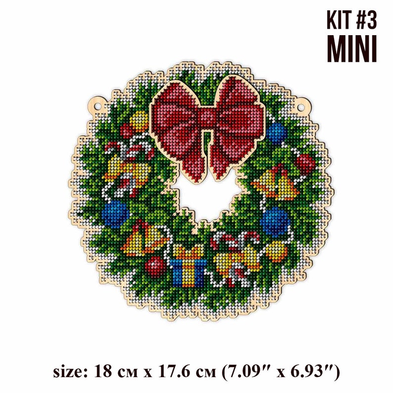 May include: A Christmas wreath embroidery kit with a red bow, green pine branches, and colorful ornaments. The kit is labeled "KIT #3 MINI" and measures 7.09 inches by 6.93 inches.