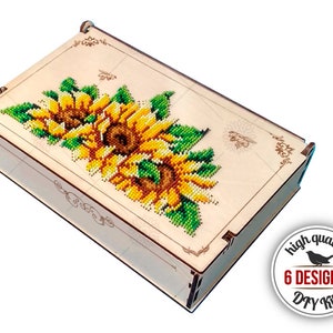 May include: A wooden box with a sunflower design. The box is made of wood and has a hinged lid. The sunflower design is made of beads and is very detailed. The box is a DIY kit and comes with 6 different designs.