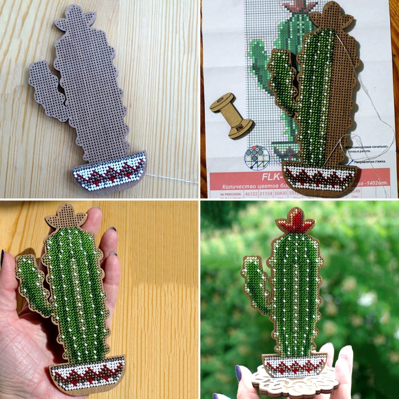 May include: Wooden cactus-shaped craft with a cross-stitch design. The cactus is green with white dots and a red flower. The base features a cross-stitched pattern in red, white, and brown. The craft is on a wooden base.
