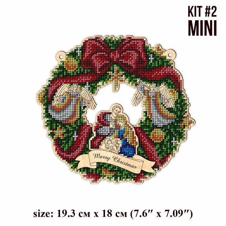 May include: A wooden Christmas wreath with a red bow, two angels, and a nativity scene in the center. The wreath is decorated with green pine needles, red berries, and gold stars. The text "Merry Christmas" is written on a banner below the nativity scene. The wreath is 7.6 inches by 7.09 inches.