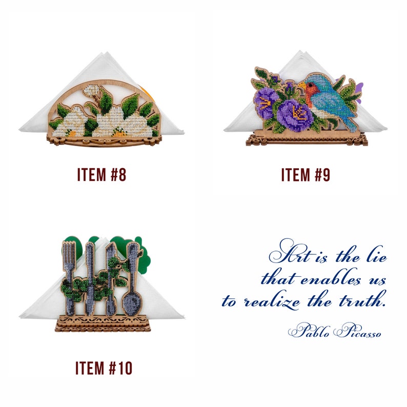 May include: Three wooden napkin holders with different embroidered designs. The first holder features a white flower design, the second has a blue bird and purple flowers, and the third has a green design with a fork, knife, and spoon.