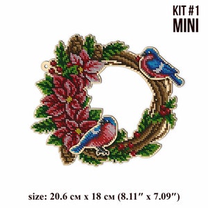 May include: A wooden Christmas wreath with red poinsettia flowers, green leaves, and two blue birds. The wreath is 8.11 inches by 7.09 inches.