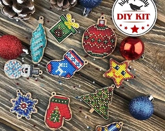 May include: A DIY kit of 12 Christmas ornaments featuring various designs, including a snowman, a stocking, a Christmas tree, a snowflake, a mitten, a bell, a star, and a gift box. The ornaments are made of wood and have a colorful, beaded design. The kit includes all the necessary materials to create the ornaments.