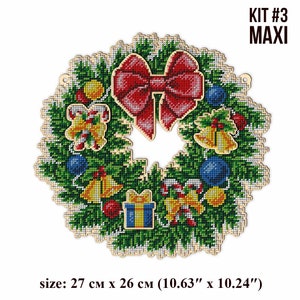 May include: A Christmas wreath with a red bow, candy canes, bells, and ornaments. The wreath is made of green pine branches and is 10.63 inches by 10.24 inches.