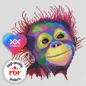 May include: Colorful cross-stitch pattern of an orangutan with a bright purple face, yellow eyes, and a big smile. The pattern is in a heart shape and includes the text "high quality PDF pattern".