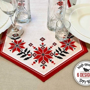 May include: A white table runner with a red border and a black and red embroidered design of flowers. The runner is on a table with glasses and plates. The text "high quality 6 DESIGNS! DIY kit" is on a white circle with a black bird.