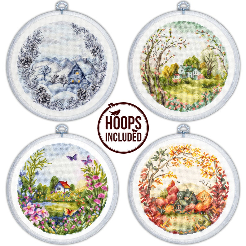 May include: Four round embroidery hoops with different scenes depicting the four seasons. The top left hoop shows a winter scene with a snowy house and trees. The top right hoop shows a spring scene with a house and blooming trees. The bottom left hoop shows a summer scene with a house, a pond, and flowers. The bottom right hoop shows a fall scene with a house and trees with red and orange leaves. "HOOPS INCLUDED" is written in brown text on a white background.