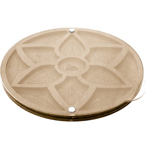 May include: A round wooden tray with a decorative floral design. The tray has six compartments and a swan logo in the center.