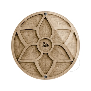 May include: A round wooden box with a carved floral design and a black swan logo in the center. The box has a hinged lid and is made of light brown wood.