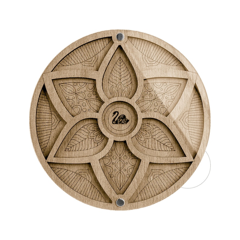 May include: A round wooden box with a carved floral design and a black swan logo in the center. The box has a hinged lid and is made of light brown wood.
