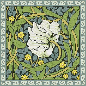 May include: A cross-stitch pattern featuring a white flower with green leaves and yellow flowers on a dark blue background. The pattern is framed with a light blue and white border.