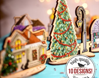 May include: A set of 10 DIY Christmas-themed cross-stitch kits featuring a variety of designs, including a house, a Christmas tree, and a street lamp. The kits are made of wood and come with all the necessary materials to complete the projects. The image also includes the text "high quality 10 DESIGNS! DIY Kits".
