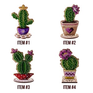 May include: Four decorative cactus designs, each in a pot, with the text "ITEM #" followed by a number. The cacti are green with purple flowers, and the pots have various colors and patterns. Each cactus sits on a decorative wooden base.