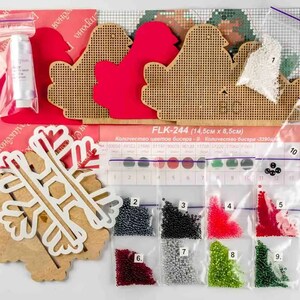 May include: A Christmas craft kit with a snowflake, two birds, and a red heart. The kit includes nine bags of beads in various colors, including red, green, black, and silver. The kit is labeled "FLK-244 (14.5cm x 8.5cm)".