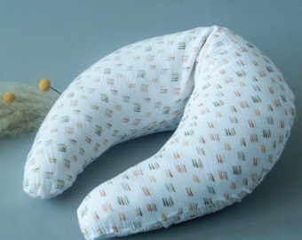 May include: A white, crescent-shaped nursing pillow with a colorful geometric pattern. The pillow is made of soft, breathable fabric and is designed to provide support and comfort for both mother and baby during breastfeeding.