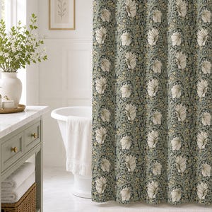 May include: A shower curtain featuring a repeating botanical pattern with large cream-colored flowers, winding green stems, and small yellow blossoms set against a dark sage green background, creating a dense and intricate floral textile design.