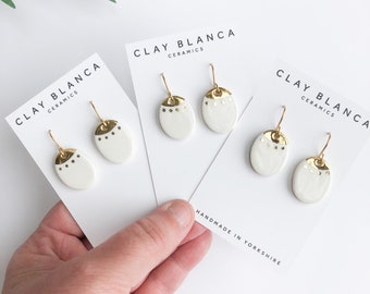 White oval porcelain dangle earrings with gold lustre - on gold plated hooks