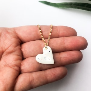 Speckled white heart necklace on gold plated chain