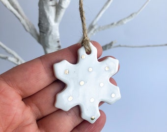 White snowflake ornament with gold dots
