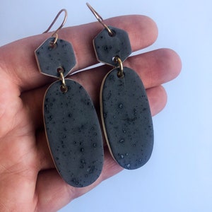 Black oval earrings on gold plated wires