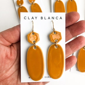 Mustard yellow oval earrings on gold plated wires