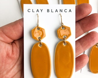 Mustard yellow oval earrings on gold plated wires