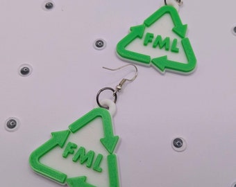 May include: A pair of green and white triangle shaped earrings with the acronym "FML" printed on them.