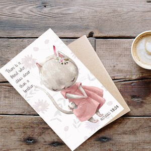 May include: A white cat with pink ears and a pink dress is holding a small bird. The cat is surrounded by pink flowers and the text "There is a friend who sticks closer than a brother." is in the top left corner. The text "Proverbs 18:24" is in the bottom right corner.