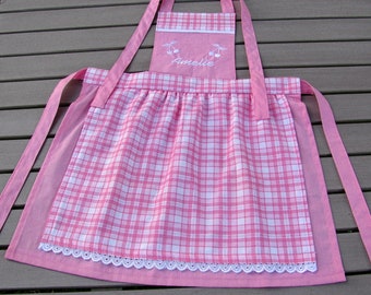 small pink-red children's apron with cherry motifs, with embroidered name, available in size. 92 to 122