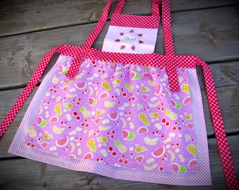 pink children's apron with sweet fruits, personalized, in sizes 92 to 122