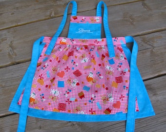 funny children's apron with name in turquoise/pink size. 86 to 122