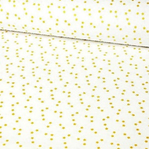 Peut inclure: Tissu blanc avec un motif répété de petites étoiles dorées. Les étoiles sont dispersées sur la surface, créant un design céleste ou festif. Le tissu est plié, suggérant qu'il s'agit d'un rouleau de matériau.