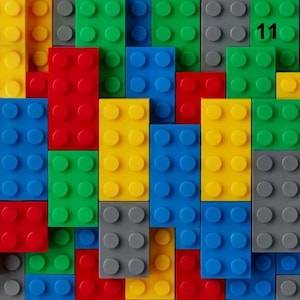 May include: A vibrant assortment of interlocking toy bricks in red, yellow, green, blue, and grey. The number "11" is visible in the top right corner. The bricks are arranged in a grid-like pattern, creating a colourful and playful design, suitable for children.