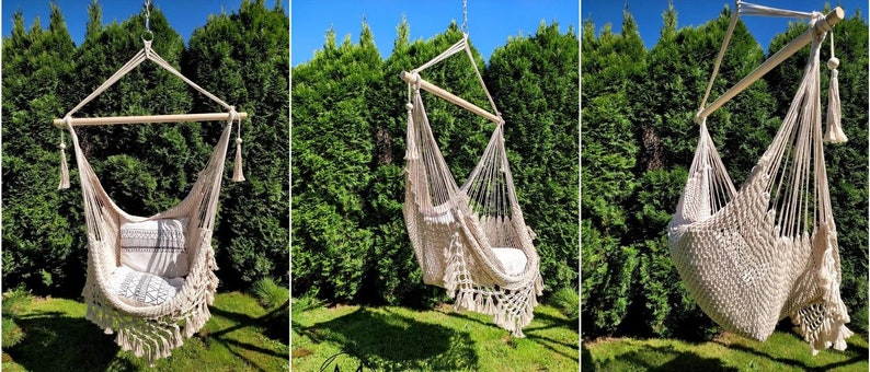 May include: A beige hammock chair with fringe hanging from a wooden frame in a backyard setting. The chair is made of woven rope and has a white and gray patterned cushion.