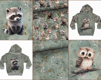May include: A set of four fabric designs featuring woodland animals, including raccoons, owls, and bears. The designs are printed on a light green background with a watercolour effect.