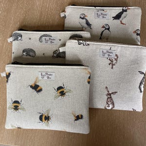 May include: A set of three ceramic mugs with a speckled, matte finish. Each mug is a different colour: light blue, cream, and grey. The mugs have a simple, modern design and a comfortable handle.