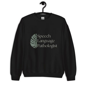 May include: Black sweatshirt with a green leaf design and the text "Speech Language Pathologist" in white.