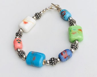 Silver tone and multi color beaded bracelet with painted flower detailing