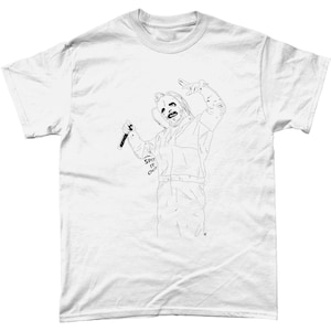 May include: A white t-shirt with a black line drawing of a person wearing a jumpsuit and holding a microphone. The person has a mask on their face and the text "SPIT IT OUT" is written on their arm.