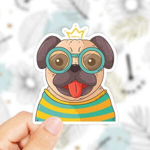 May include: A cartoon pug wearing round blue sunglasses and a yellow and blue striped shirt with a gold crown on its head.