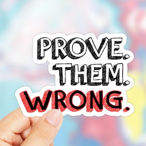 Puede incluir: Una pegatina blanca con letras negras y rojas que dice "PROVE. THEM. WRONG."