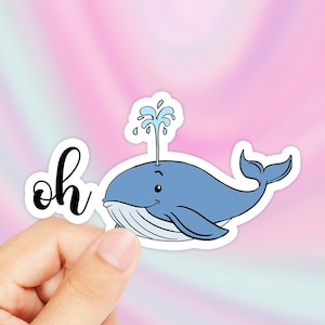 May include: A sticker with a blue whale with a spout of water on top and the word "oh" in black cursive.