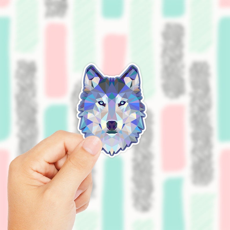 May include: Geometric wolf head sticker with blue, purple, and white colors. The sticker is on a white background.