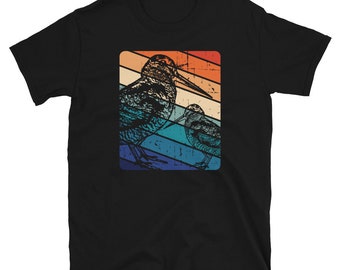 May include: A black t-shirt with a vintage-style graphic of two birds. The birds are in a retro color palette of blue, orange, and yellow. The graphic is surrounded by a white border.