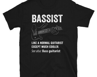 May include: Black t-shirt with white text that reads "Bassist Like a normal guitarist except much cooler. See also: Bass guitarist". A white outline of a bass guitar and hands playing the guitar are also on the shirt.