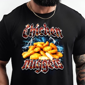 May include: Black t-shirt with a graphic of chicken nuggets in a fiery, electric design. The text "Chicken Nuggets" is in a bold, gothic font.