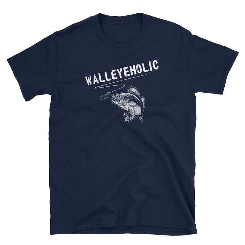 May include: Navy blue t-shirt with a white graphic of a walleye fish on a fishing line and the text "WALLEYEHOLIC".