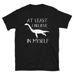 May include: Black t-shirt with a white graphic of a sea monster and the text "At Least I Believe In Myself".